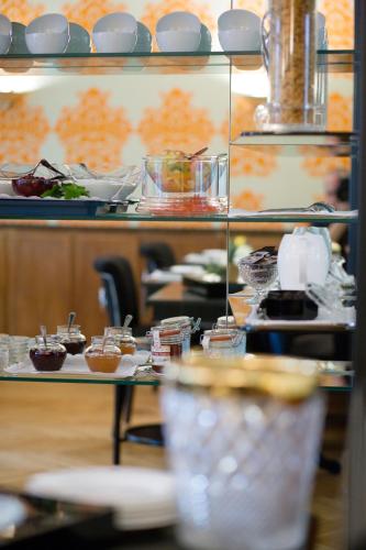a kitchen with plates of food on a table at Top Hotel Krämer in Koblenz