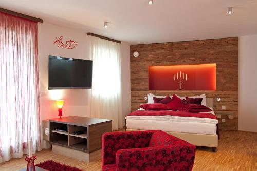 a bedroom with a large bed with red pillows at Deluxe Apartment Sonnleitner - ADULTS ONLY in Furth