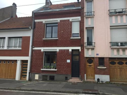 a brick apartment building with a front door at Les Chambres du Verger in Amiens