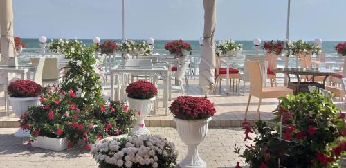a group of flowers in white vases on a patio at Shalanda in Odesa