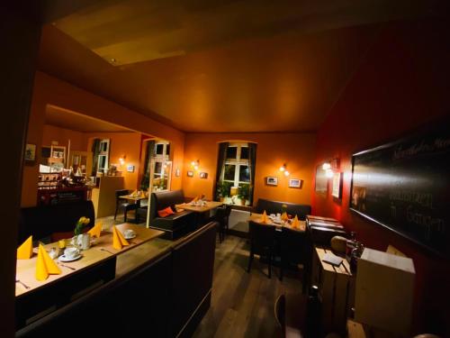 a dining room with tables and chairs in a restaurant at Landhaus Hammoor Stieper Gastronomie GmbH in Hammoor