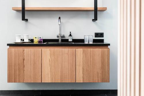 a kitchen with a sink and a counter at AMELIA rooms in Tirolo
