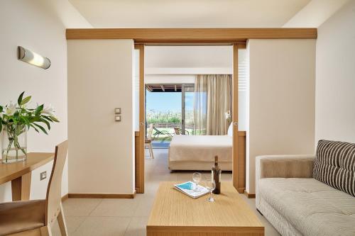 a living room with a couch and a bed at Princess Sun Hotel in Kiotari