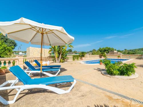 two lounge chairs and an umbrella on a beach at Holiday Home Can Josepot by Interhome in Alcudia