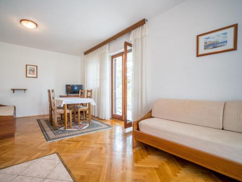 a living room with a couch and a table at Apartment Fuma-3 by Interhome in Jadranovo