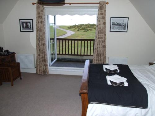 a bedroom with a bed and a large window at The Curragh Country House Accommodation in Newbridge