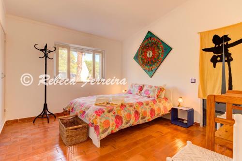 a room with a bed and a window at Villa Caramu - rustic 3 bedroom villa with private pool and great seaviews in Lagoa