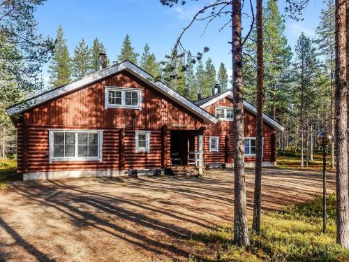 a log cabin in the woods with a driveway at Holiday Home Kiepinkulma a by Interhome in Levi