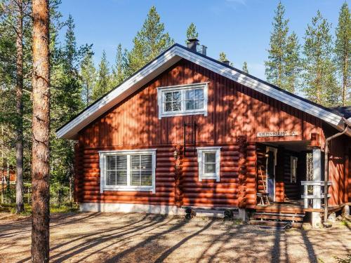 a log cabin in the woods with trees at Holiday Home Kiepinkulma a by Interhome in Levi