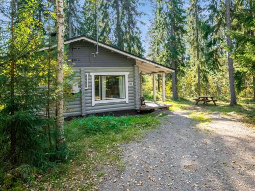 a cabin in the woods with a picnic table at Holiday Home Viinakorpi by Interhome in Somerniemi