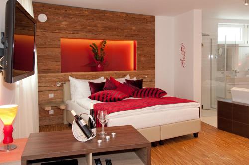 a bedroom with a bed with red pillows on it at Deluxe Apartment Sonnleitner - ADULTS ONLY in Furth