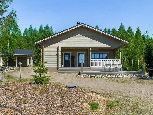 a small house with a large porch and a porch at Holiday Home Villa mari by Interhome in Pertunmaa