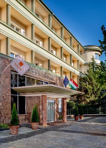 a hotel building with flags in front of it at Mamaison Hotel Andrassy Budapest in Budapest