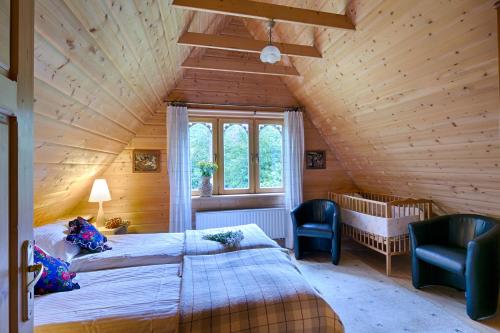 a bedroom with two beds in a wooden house at Domek regionalny Akwarela centrum sauna in Zakopane