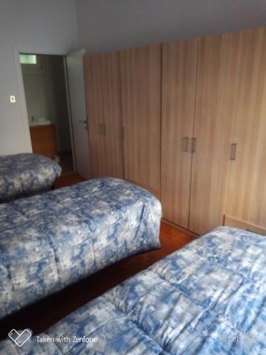 パドヴァにあるbarbarigoのベッドルーム(ベッド2台、木製キャビネット付)