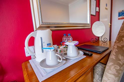 a sewing machine sitting on top of a wooden table at The Station Guest House in Woodbridge