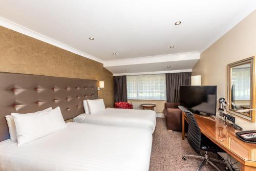 a hotel room with two beds and a desk at Holiday Inn Dover by IHG in Dover
