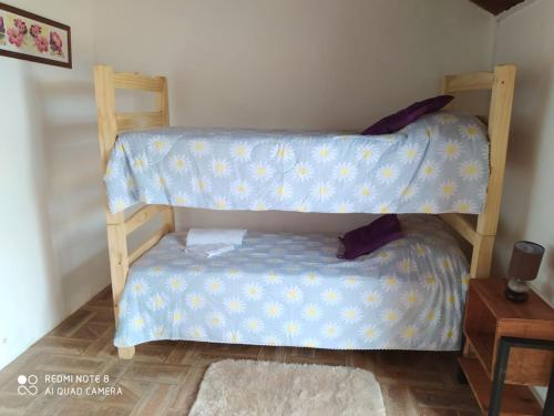 a bedroom with two bunk beds and a table at El Destacamento in Villa Serrana