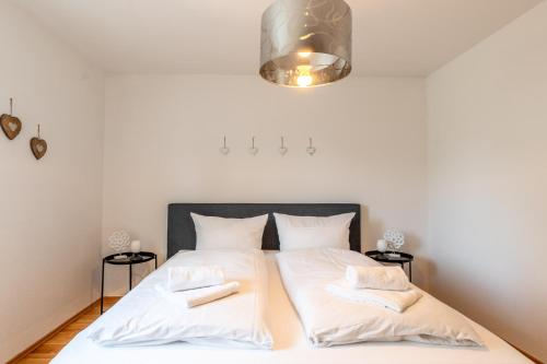 ein Schlafzimmer mit zwei Betten mit weißer Bettwäsche in der Unterkunft Alpenglöckchen in Sonthofen