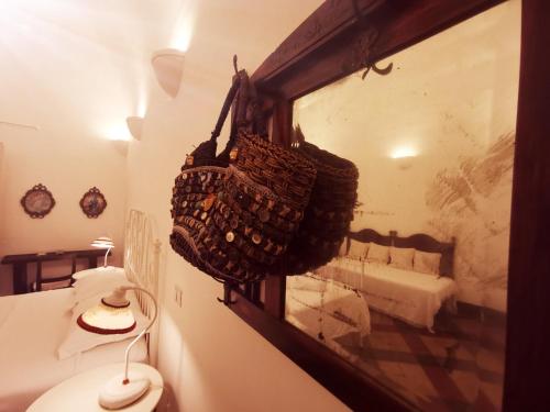 a bathroom with a basket hanging on the wall at Fera O' Luni in Catania