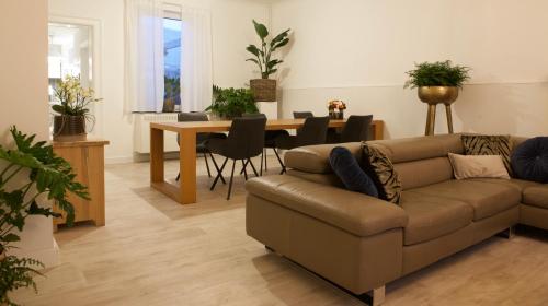a living room with a couch and a table at Vakantiewoning Oudsbergen in Oudsbergen 