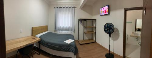 Cama ou camas em um quarto em Hotel Aliança Barbacena