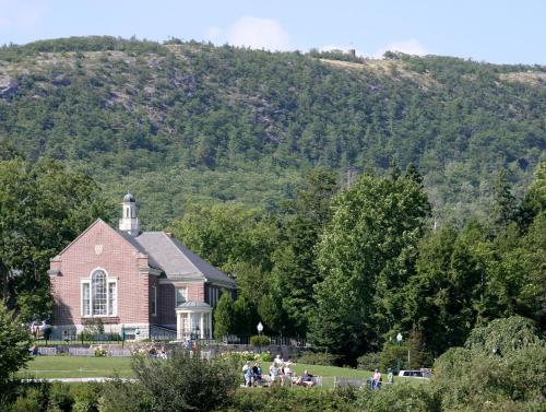 a church in front of a mountain with people standing outside at Lord Camden Inn in Camden