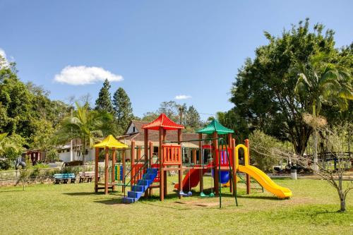 a playground with a slide in a park at Hotel Fazenda Casarão do Vale Hotel in Massaranduba