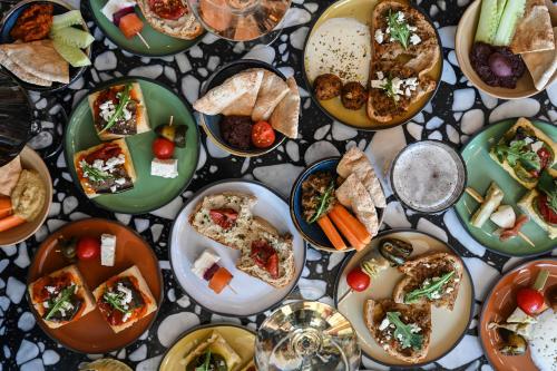 a table full of plates of food on a table at OKKO Hotels Lyon Centre in Lyon