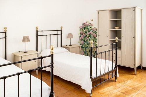 1 dormitorio con 2 camas y un armario con flores en B&B Murolungo, en San Lazzaro di Savena