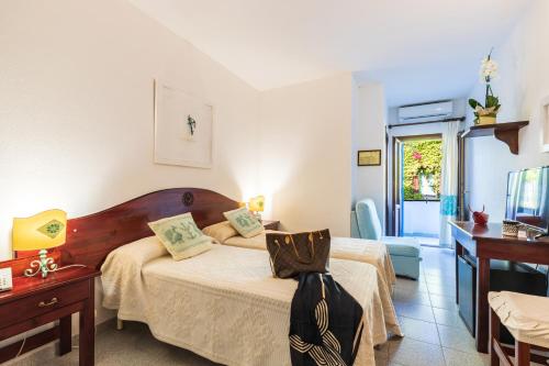 Postel nebo postele na pokoji v ubytování Hotel S'Ortale con Parcheggio interno e Ristorante all'aperto