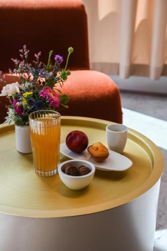a table with a tray with food and drinks on it at OKKO Hotels Lyon Centre in Lyon