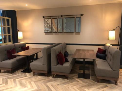 a living room filled with furniture and a couch at The Aberdeen Altens Hotel in Aberdeen