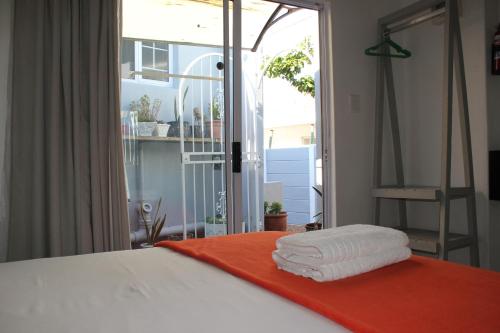 a bedroom with a bed with two towels on it at 25 on Fitzpatrick in Parow