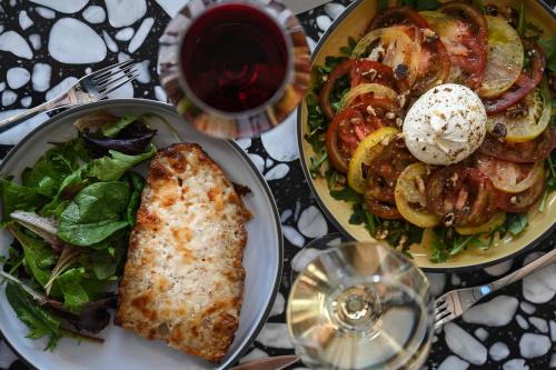 a table with two plates of food and a salad at OKKO Hotels Cannes Centre in Cannes