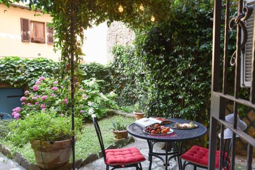
a table with a basket of fruit on it next to a patio at Casa Amorino- Together Tuscany in Cortona

