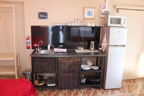 a small kitchen with a sink and a refrigerator at 25 on Fitzpatrick in Parow