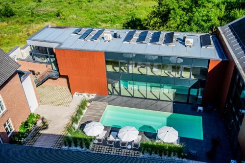 an aerial view of a building with a swimming pool at Hof van Stayen in Sint-Truiden
