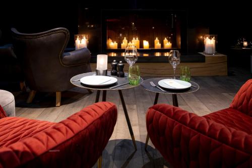 a restaurant with two tables and chairs and candles at SlowDown Travemünde in Travemünde