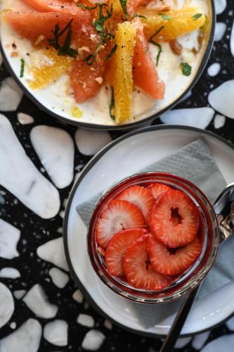 two plates of food with strawberries on a table at OKKO Hotels Bayonne Centre in Bayonne