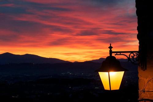a street light with a sunset in the background at Residenza Buggiano Antica B&B - Charme Apartment in Tuscany in Borgo a Buggiano