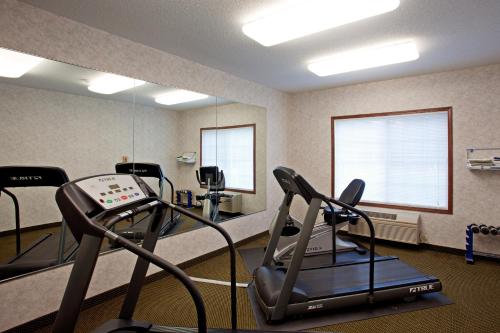 a fitness room with a treadmill and a mirror at Country Inn & Suites by Radisson, Elk River, MN in Elk River
