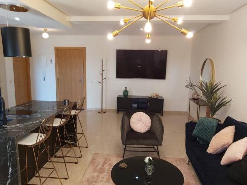 a living room with a couch and a bar at Luxueux appartement entre Gueliz et l'Hivernage avec WIFI in Marrakech