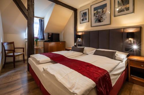 a bedroom with a large bed in a room at Pension U Lilie in Prague