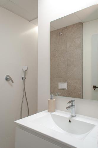 a bathroom with a white sink and a mirror at ABAL Apartments - Barrio in Alicante