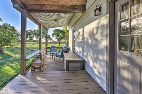 a wooden porch with chairs and a bench at Day Trip to Waco and Temple House on Cattle Farm in Lorena