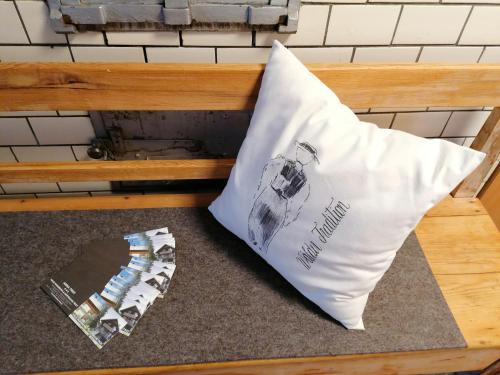 a pillow and a magazine sitting on a bench at Ferienhaus Troy in Doren