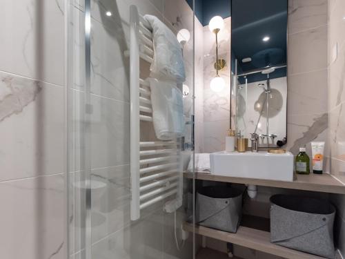 a bathroom with a sink and a glass shower at Luxury Apartment "Le Raffiné" - Lyon Part-Dieu - Dreamy Flat Lyon in Lyon