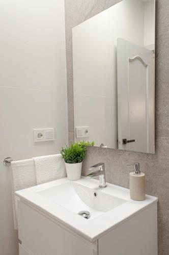 a bathroom with a white sink and a mirror at ABAL Apartments - Barrio in Alicante