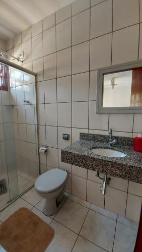 a bathroom with a toilet and a sink and a shower at Pousada Nativa's in São Luiz do Paraitinga